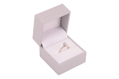 Lot 40 - An emerald-cut diamond solitaire ring in 14ct...