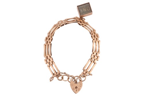 Lot 314 - A gate link bracelet in 9ct gold, suspending...