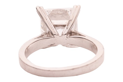Lot 244 - A princess-cut diamond solitaire ring,...