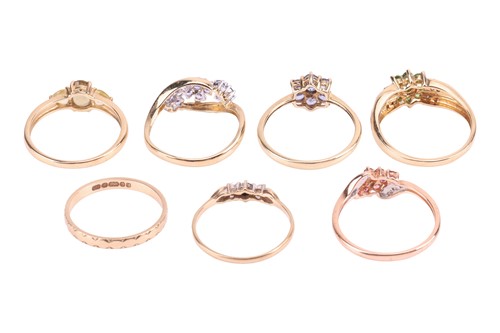 Lot 23 - Six gem-set rings and a plain band all set in...