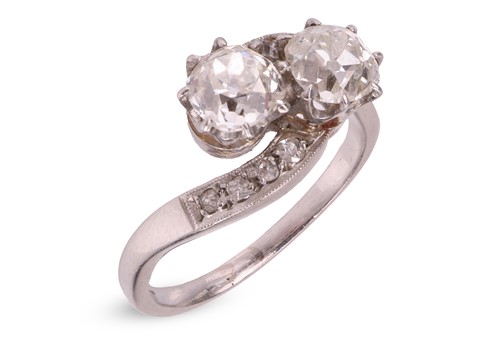 Lot 76 - A diamond-set crossover ring, claw-set with...