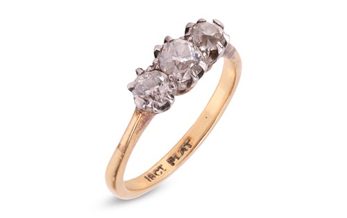 Lot 29 - A three stone diamond ring featuring three...