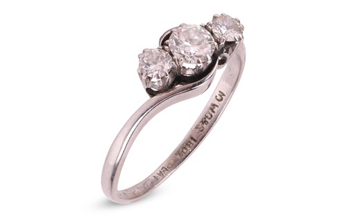 Lot 29 - A three-stone diamond ring, of bypass design,...