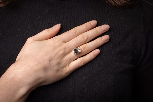 Lot 62 - Kutchinsky - an emerald-cut diamond solitaire,...