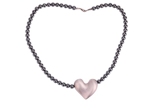 Lot 320 - Georg Jensen – A heart pendant on a hematite...