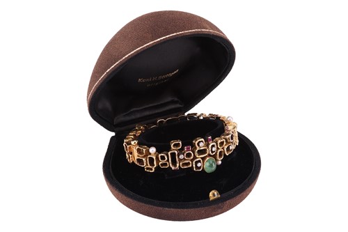 Lot 56 - A Modernist multi-gem bangle, designed by Karl...