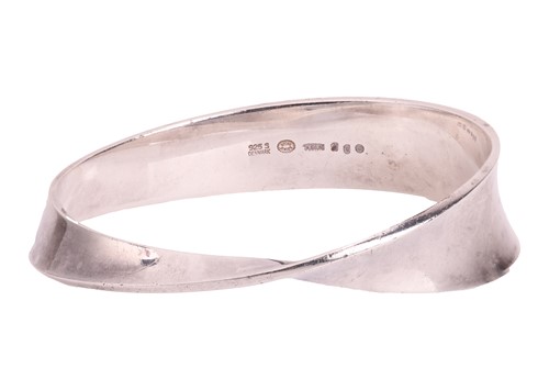 Lot 276 - Georg Jensen - A silver 'Möbius' closed bangle,...