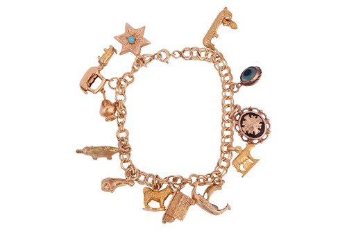 Lot 73 - A charm bracelet, comprising a series of...