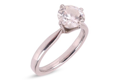 Lot 146 - A diamond solitaire ring in platinum, claw-set...