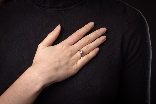 Lot 146 - A diamond solitaire ring in platinum, claw-set...