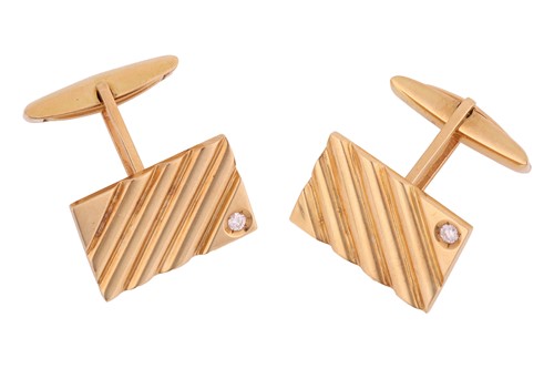 Lot 14 - A pair of cufflinks with diamond accents, each...