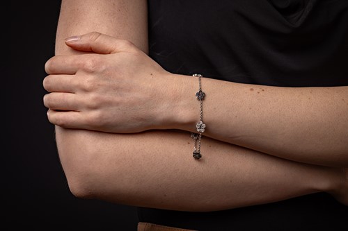 Lot 239 - Boodles - a diamond-set 'Blossom' charm...