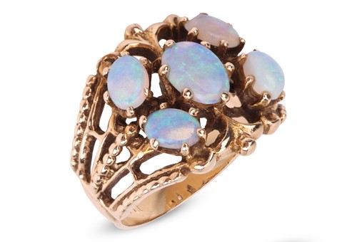 Lot 15 - An opal cluster ring, the openwork mount with...