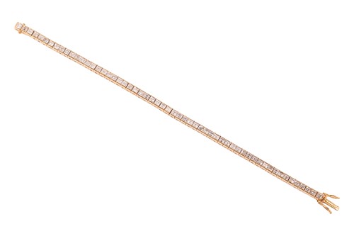 Lot 252 - A diamond line bracelet, with an estimated...