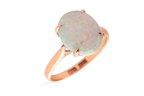 Lot 34 - An opal dress ring, claw-set with a precious...