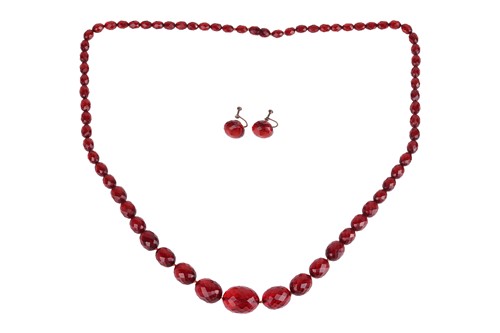 Lot 25 - A cherry bakelite necklace and earrings set;...