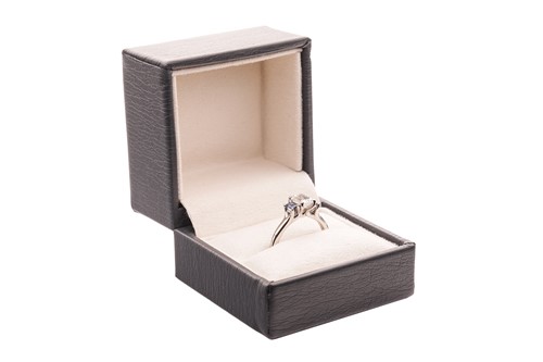 Lot 296 - A diamond and sapphire trilogy ring, featuring...