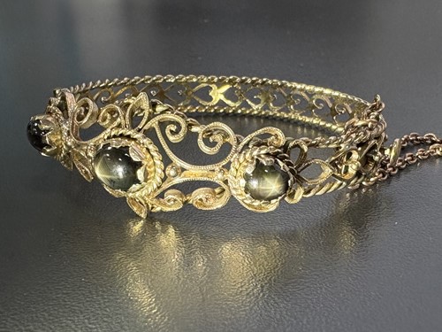 Lot 33 - A hinged bracelet set with black star...
