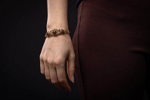 Lot 33 - A hinged bracelet set with black star...