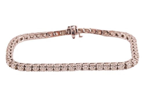 Lot 182 - A diamond line bracelet, comprising fifty-two...