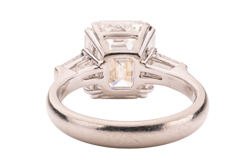 Lot 182 - An emerald-cut diamond solitaire ring, the...