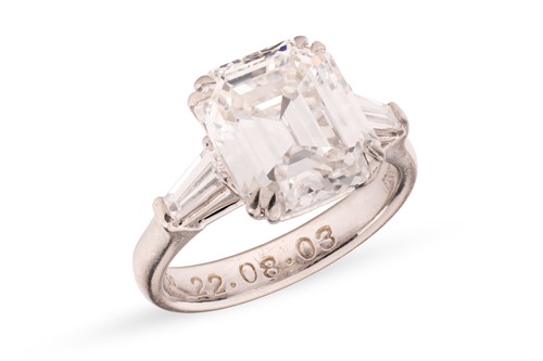 Lot 182 - An emerald-cut diamond solitaire ring, the...