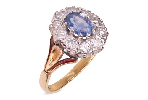 Lot 36 - A sapphire and diamond cluster ring in 18ct,...