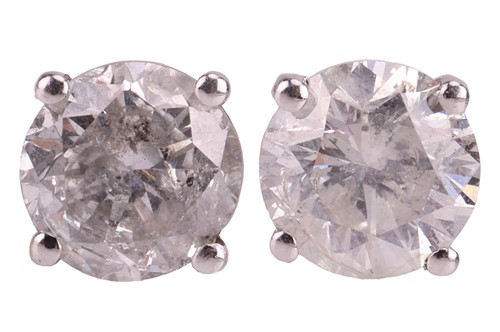 Lot 106 - A pair of diamond stud earrings, claw-set with...