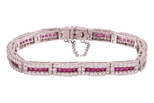 Lot 80 - A ruby and diamond line bracelet, each hinged...