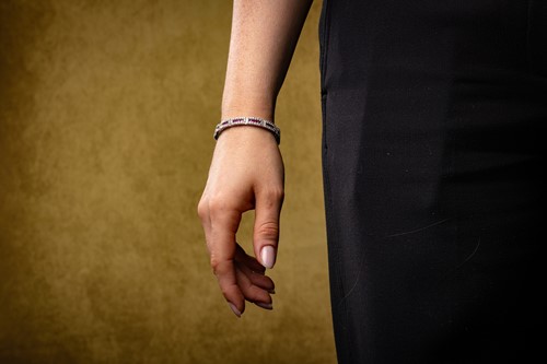 Lot 80 - A ruby and diamond line bracelet, each hinged...