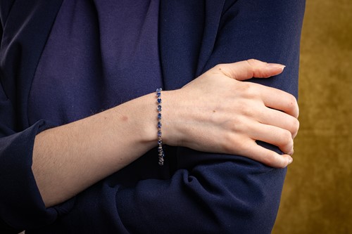 Lot 113 - A sapphire and diamond line bracelet,...