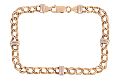 Lot 166 - A two-toned double curb link bracelet in 18ct...