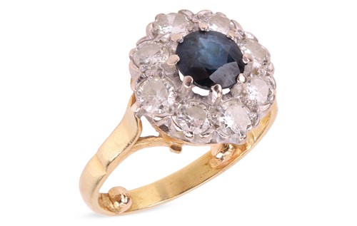 Lot 18 - A sapphire and diamond cluster ring in 18ct...