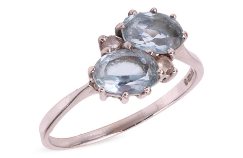 Lot 100 - An aquamarine crossover ring in 18ct white...