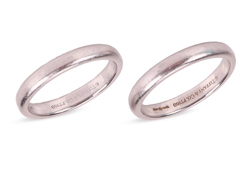 Lot 238 - Tiffany - A pair of platinum band rings by...