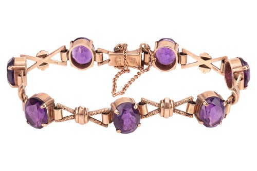 Lot 40 - A fancy link bracelet set with amethyst in 9ct...