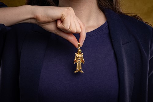 Lot 56 - A gem-set clown pendant, of stylised design...