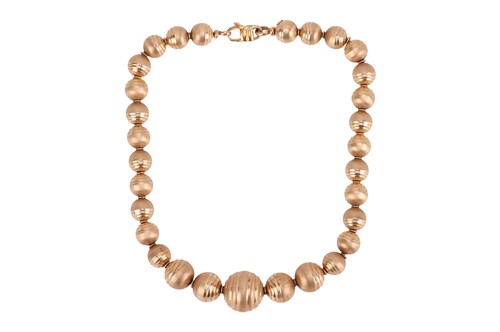 Lot 124 - A textured bead necklace, featuring graduated...