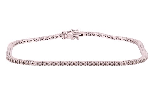 Lot 78 - A diamond-set tennis bracelet, claw-set with...
