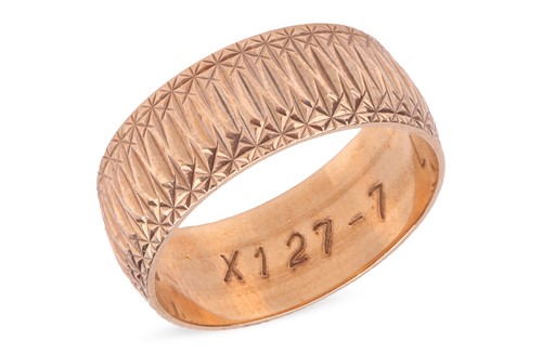 Lot 48 - A dress ring in 9ct yellow gold, the wide band...