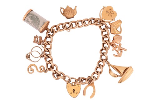 Lot 54 - A charm bracelet in 9ct yellow gold,...