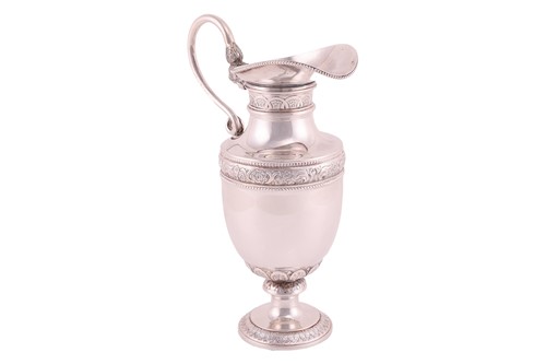 Lot 281 - A white metal ewer, on a spreading foot, body...
