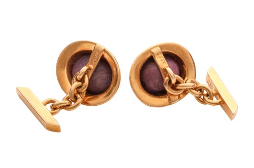 Lot 98 - A pair of star ruby cufflinks, the oval...