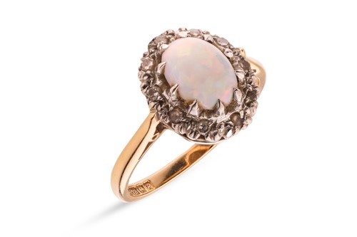 Lot 17 - An opal and diamond cluster ring in 18ct gold,...