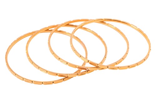 Lot 147 - A set of four Indian bangles; each bangle of...