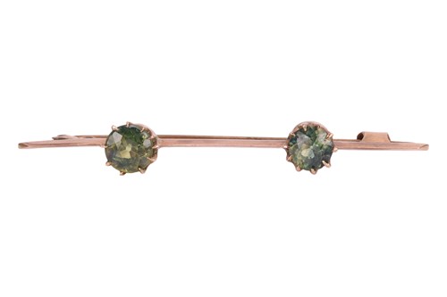 Lot 60 - A two-stone green zircon bar brooch, claw-set...