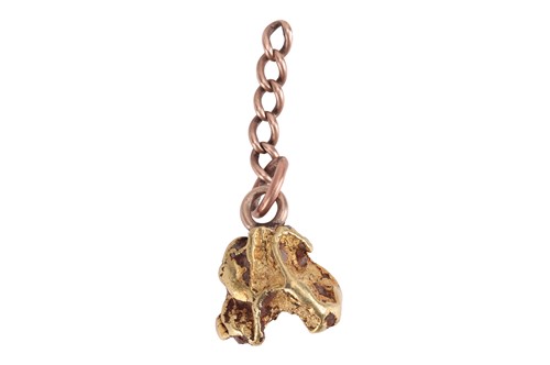 Lot 112 - A nugget charm, featuring a yellow metal...