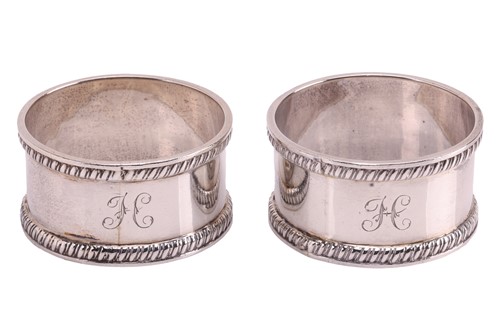 Lot 256 - A pair of cased silver napkin rings, by T H...