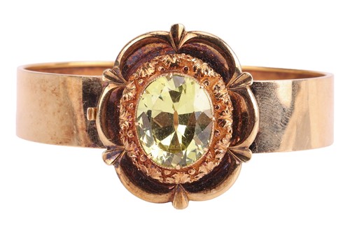 Lot 22 - A Victorian floral hinged bangle set with...