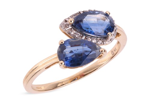 Lot 130 - A kyanite crossover ring, each confronting...